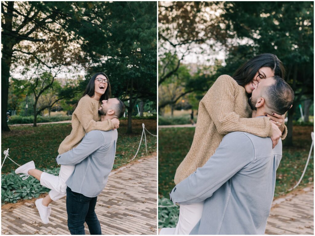 Couple candidly laughing while woman is being picked up