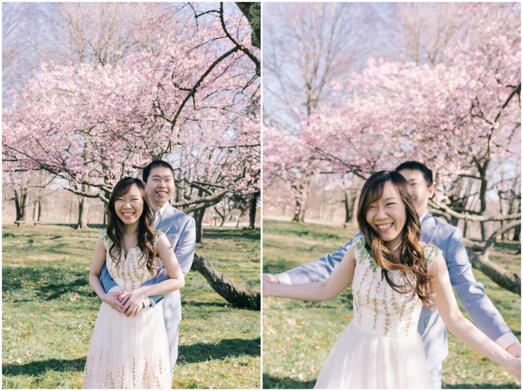 candid engagement photos in  fairmount park with cherry blossoms