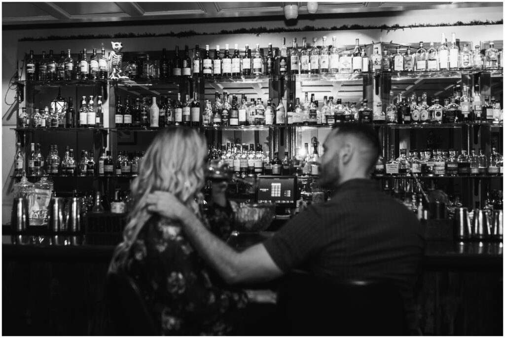 black and white couple photos at a bar
