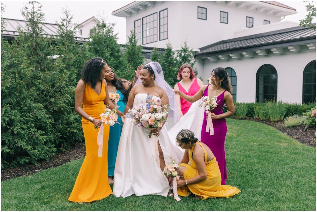 Bridesmaids fixing up bride at Perona Farms